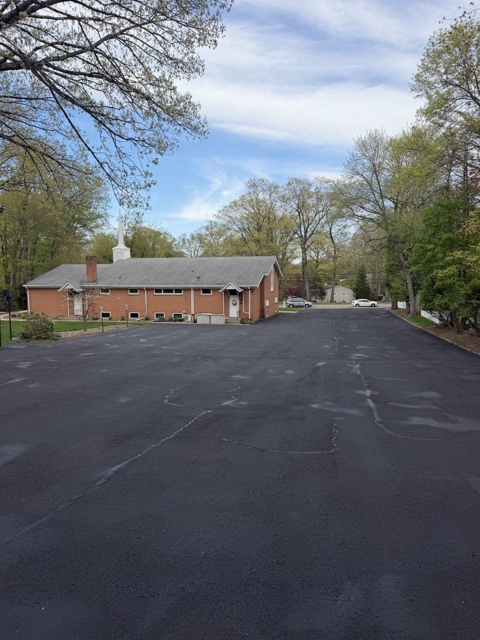 Freshly sealcoated commercial parking lot, rich black finish, River Vale, NJ