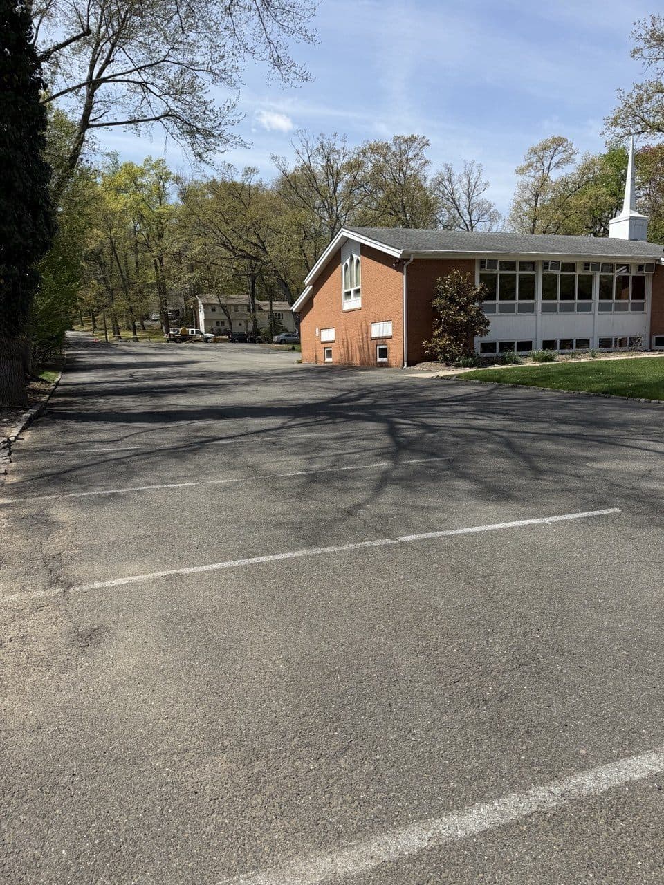 Worn church parking lot with surface cracking before sealcoating