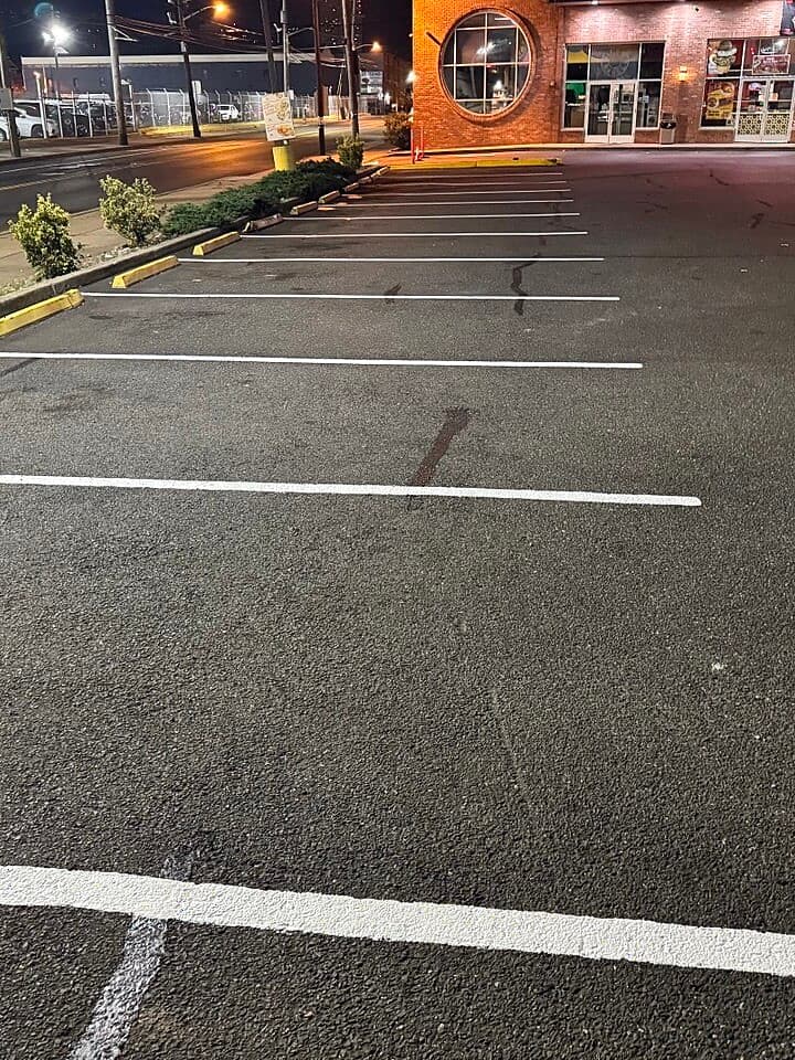 Crisp, fresh white parking stall lines at Wonder Bagels after re-striping, Jersey City, NJ