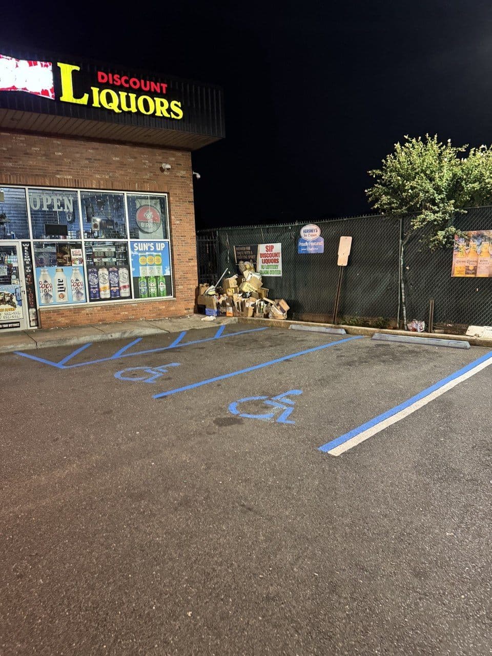 Fresh blue ADA-compliant accessible stalls after striping at Discount Liquors, Jersey City, NJ